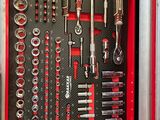 a red tool box with tools in it on the ground