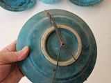 a person holding a blue plate with a hole in it