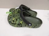 a pair of green crocs that are on a table