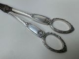 two spoons and a pair of tonges on a table