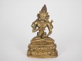 a gold statue of a person sitting on top of a table