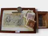 a picture of a box with stamps and a coin in it