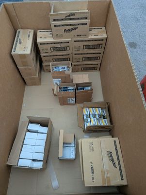 a box full of boxes of cigarettes and other items on the floor