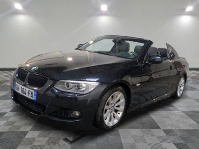 une photo d'une BMW décapotable noire garée dans un garage