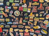 a black refrigerator covered with lots of pins and magnets
