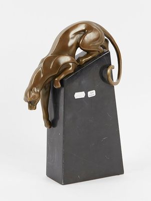 bronze sculpture of a cat on a black stand