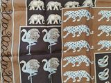 brown and blue scarf with elephants and giraffes on it