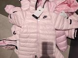 a pink puffy jacket with a black hoodie on it