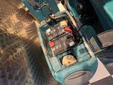 a close up of a machine that is on a checkered floor