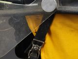 a close up of a person wearing a fireman ' s helmet and a yellow vest