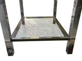 the table is made of metal and has a glass top
