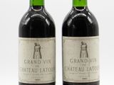 two bottles of wine sitting next to each other on a white surface