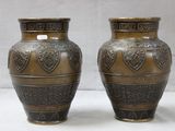 two vases sitting side by side on a white surface