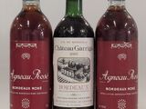 trois bouteilles de vin posées l'une à côté de l'autre sur une table