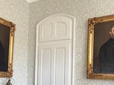 two paintings on the wall in the hallway of a house