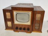an old fashioned television set with a small screen on it