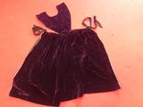 a purple dress on a table with scissors and scissors