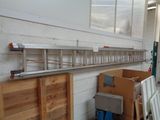 a room with a lot of boxes and a ladder on the wall