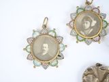 three antique photo frames are hanging on a wall next to a statue