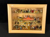 a wooden display case with a lot of perfumes in it