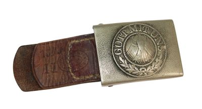 an old belt with a metal buckle on a white background