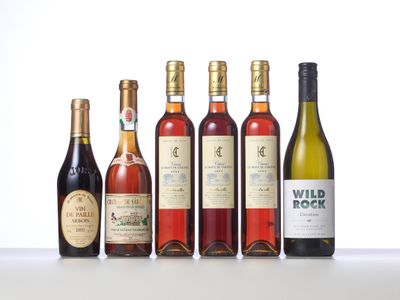 several bottles of wine are lined up on a table