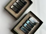 three cell phones in a box on a white surface