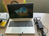 a laptop computer sitting on top of a wooden table