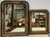 two mirrors that are on the wall next to each other