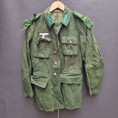 an image of a military jacket hanging on a hanger