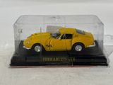 a yellow car in a glass case on a white surface