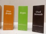 four different types of perfumes are lined up on a white surface