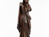 a statue of a woman in a long dress with a veil on her head