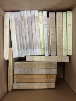 a box full of books that are stacked on top of each other