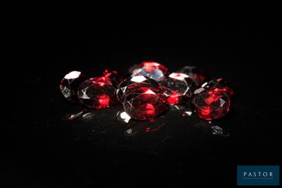 a bunch of red diamonds on a black surface