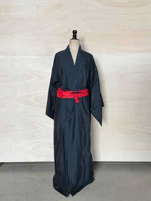 an image of a black robe with a red belt on a mannequin dummy