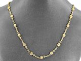 a gold necklace with flowers and leaves on a mannequin mannequin