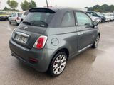 a small grey car parked in a parking lot