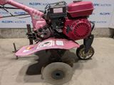 a small pink machine that is sitting on the ground