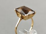 a close up of a gold ring with a smoky quartz stone in it