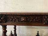 a wooden table with carvings on the top of it
