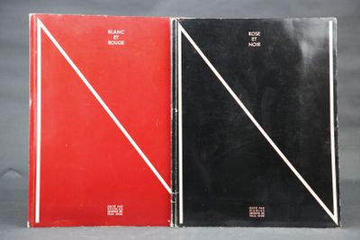 two black and red books sitting next to each other on a table