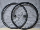 pair of black bicycle wheels sitting on a wooden surface