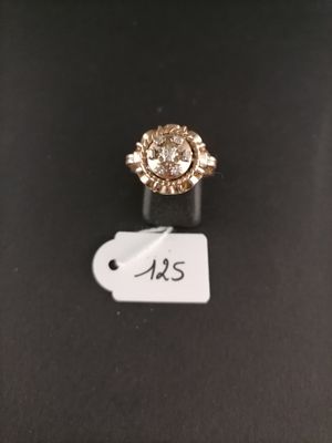 a close up of a diamond ring on a black surface