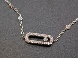 silver plated necklace with a rectangle shaped pendant with a diamond center