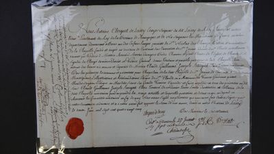 un morceau de papier portant un cachet de cire