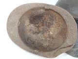 a dirty hat sitting on top of a pair of shoes