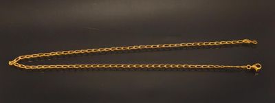 a close up of a chain on a table with a black background