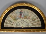 an old fan with a painting of a man and a woman on it