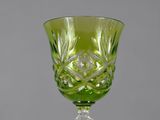 a green wine glass sitting on top of a table